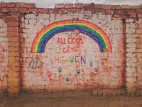 brown brick wall with graffiti